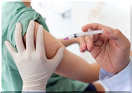 Syringe with vaccine and arm.