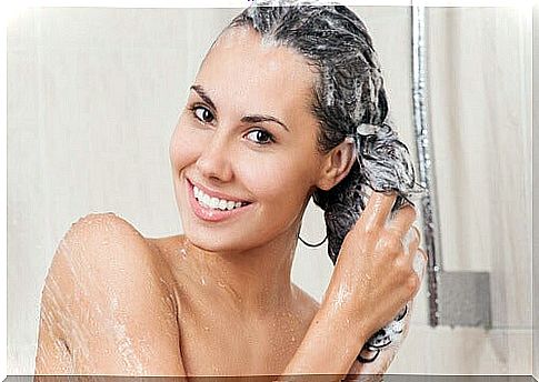 Girl washes her hair in the shower