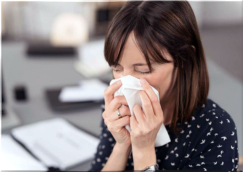 Woman blowing her nose and coronavirus spread