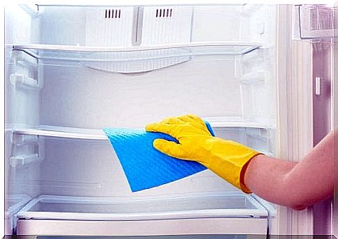 Woman cleaning the refrigerator