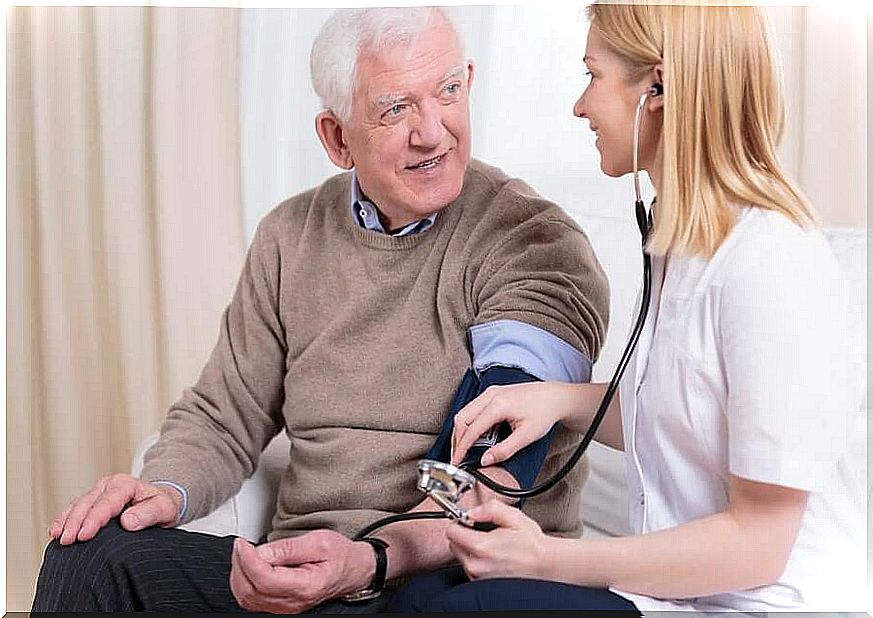 Nurse measuring the pressure to an elderly man