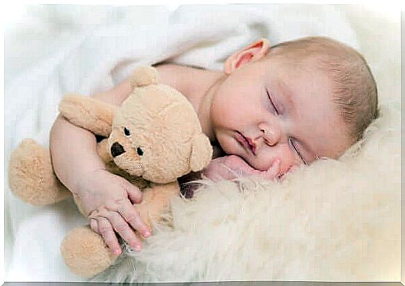 Baby sleeping with teddy bear