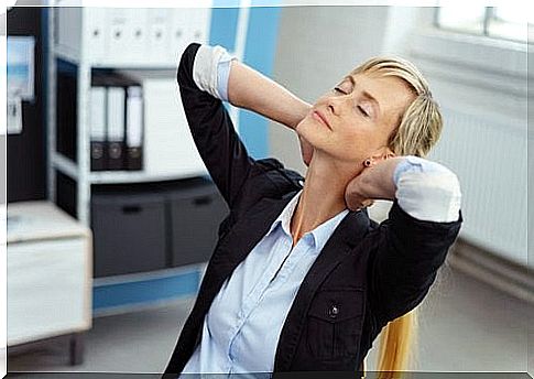 Woman in the office does neck stretching