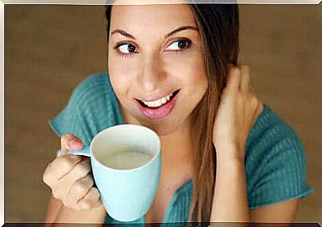 Girl drinking from a cup.