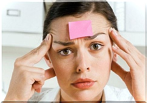 Woman with a post it note on her forehead